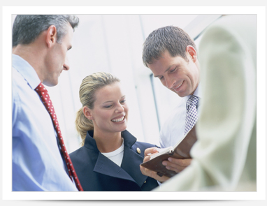 image of people smiling around a meeting table